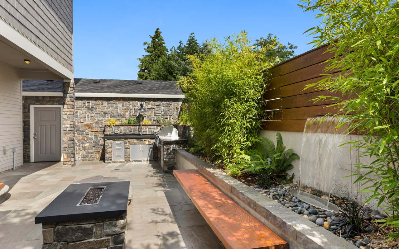 A vibrant garden focal point with colorful flowers and a water feature.